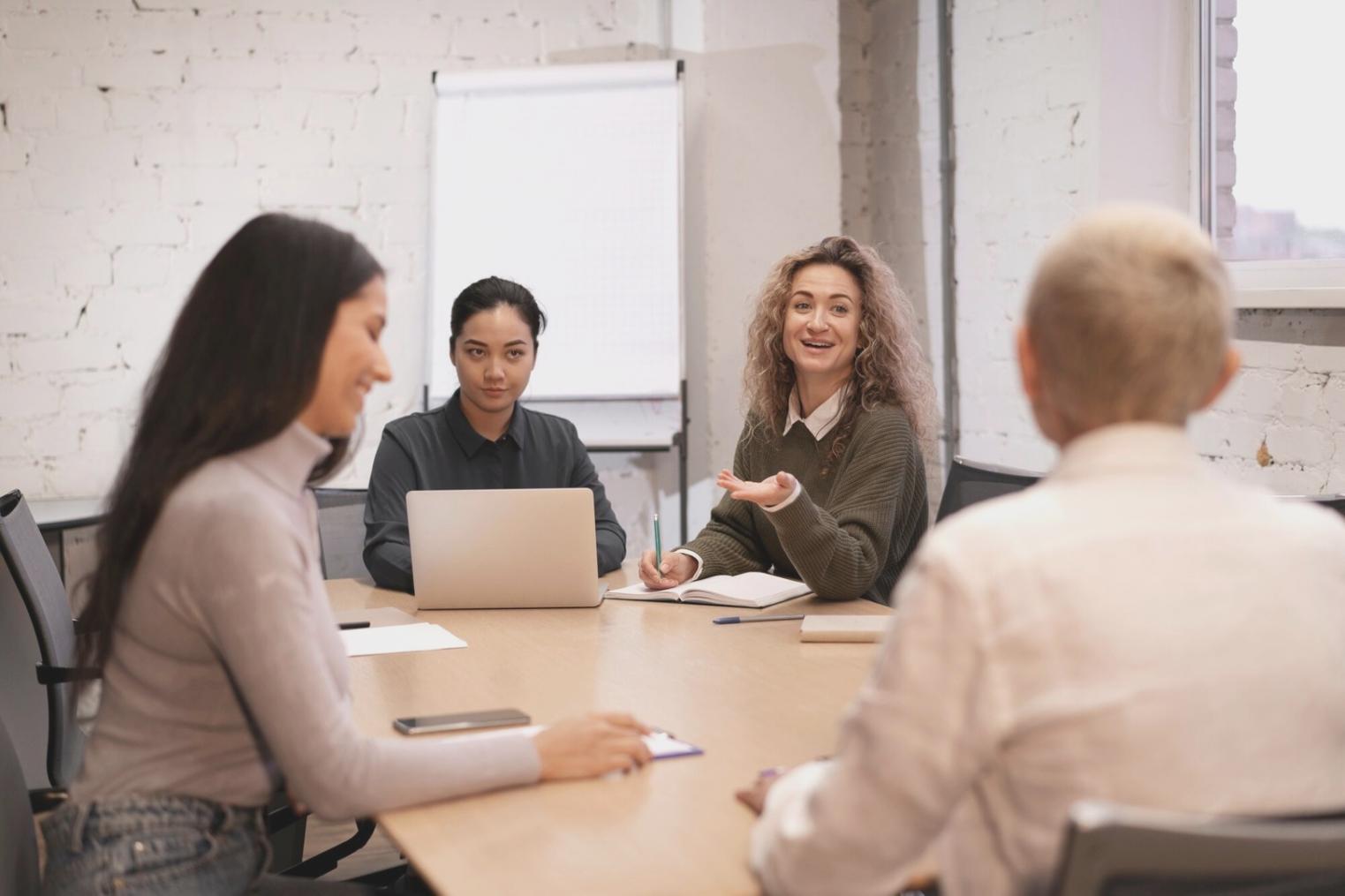 Professional presenting financial analysis to colleagues in modern conference room